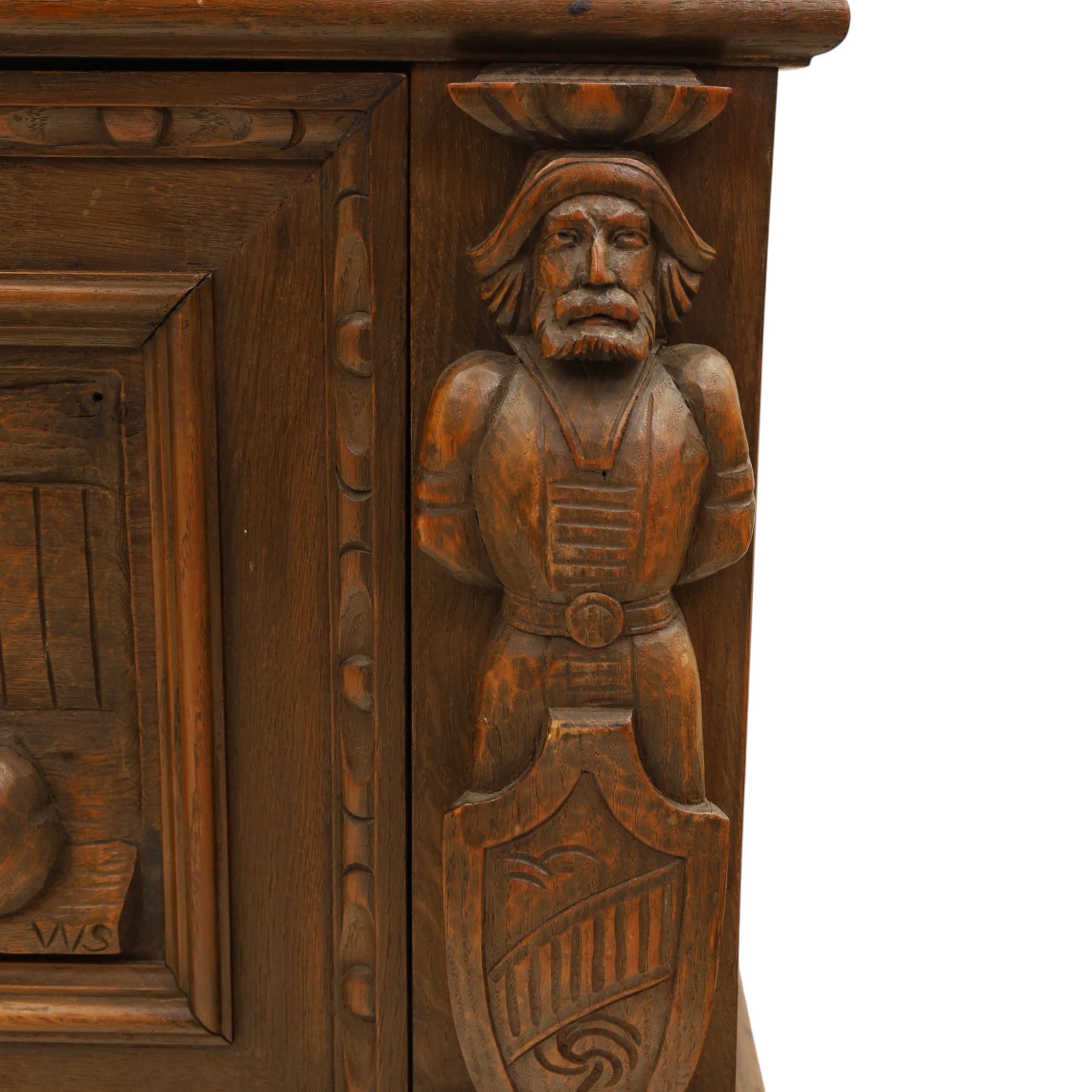 Carved oak coffer bench, rectangular moulded top above carved fall front, with figural, mask and foliate decoration, panelled sides, raised on turned bun feet with shaped lower apron