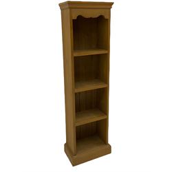 Two narrow pine open bookcases