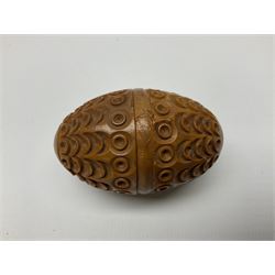 Three 19th century coquilla nut pomanders or flea catchers, each of egg shaped form with carved and pierced decoration and screw threaded join, largest example H7cm