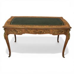 Late 19th century French kingwood and marquetry bureau plat, the serpentine rectangular top with green leather inset writing surface within crossbanded and foliate marquetry border, above a shaped frieze fitted with three drawers with floral marquetry panels and gilt metal handles, upon cabriole supports with applied gilt metal mounts and sabots