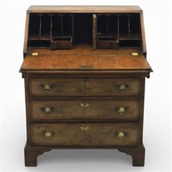 19th century walnut bureau of small proportions, the sloping fall enclosing a fitted interior with shaped pigeonholes and small drawers, above four long graduated drawers with feather banded walnut veneers, fitted with brass swan neck handles and escutcheons, raised on shaped bracket feet