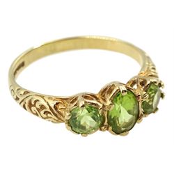 9ct gold three stone peridot ring with scroll design shoulders, hallmarked 