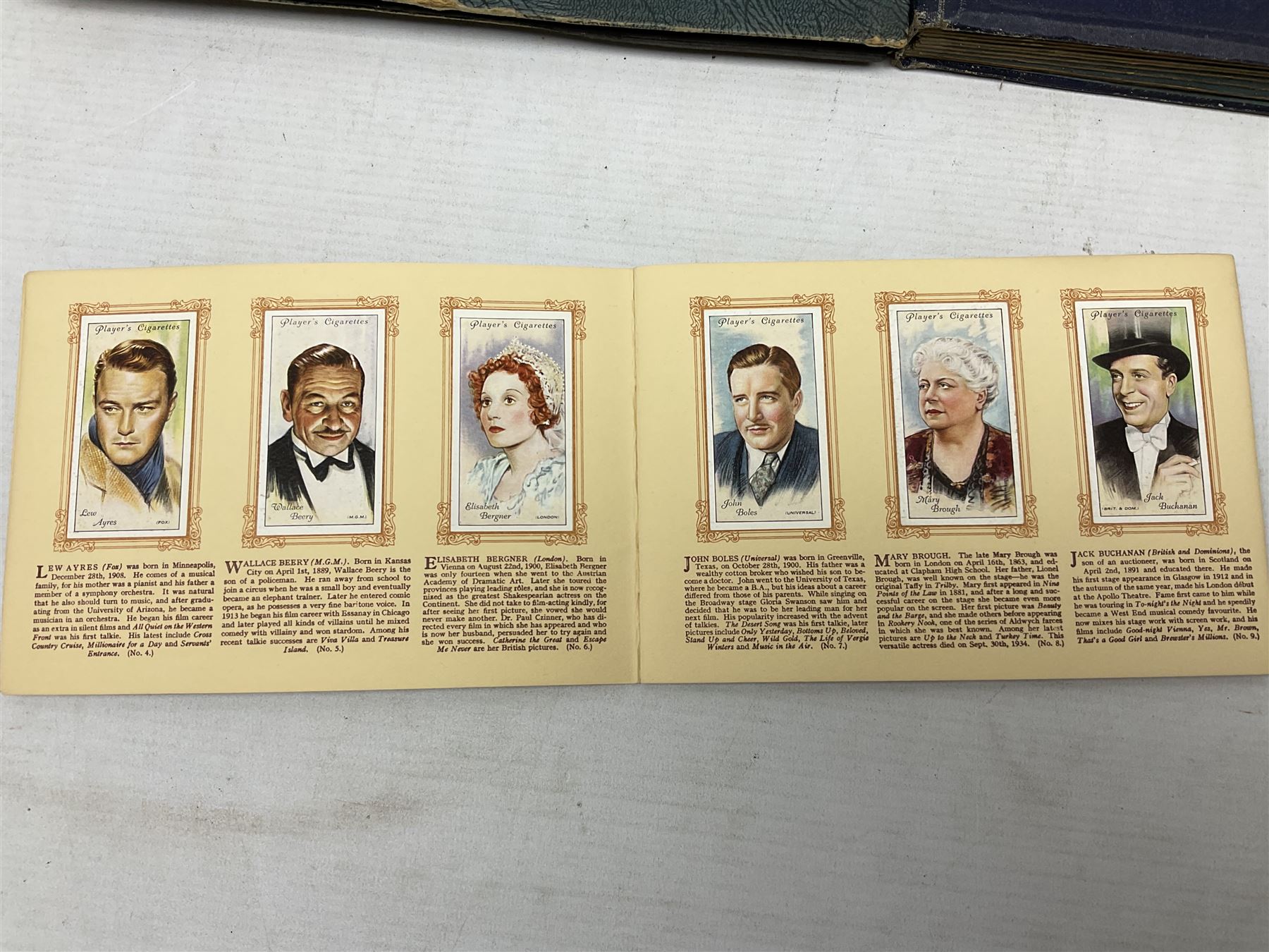 Three albums of cigarette cards including Wills Recruiting Posters, Military Motors and Allied Army Leaders, cricketers etc; another album containing a large quantity of laid-in cigarette cards; and an album of thirty-seven postcards of dogs by Mac (5)