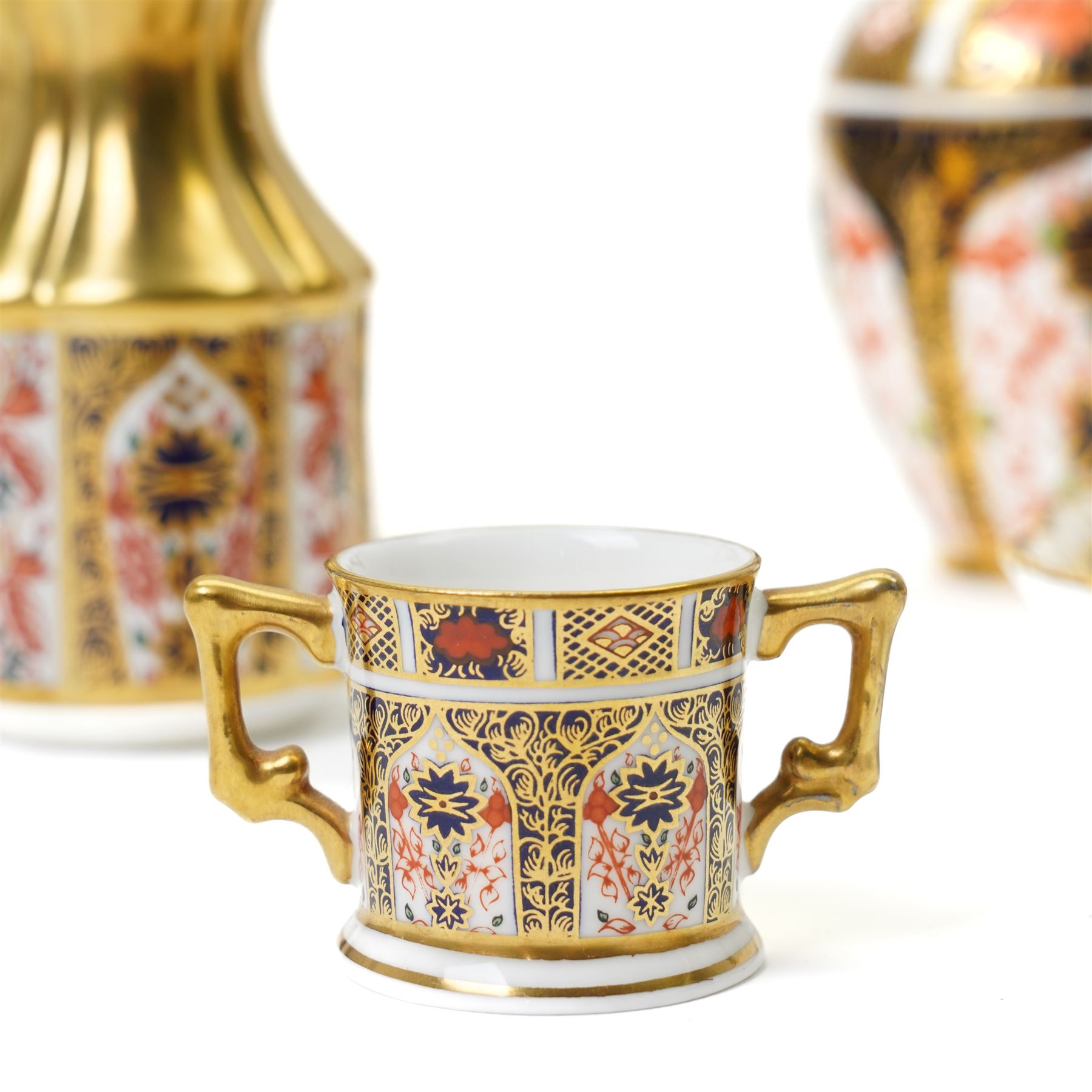 Mixed Royal Crown Derby Imari pattern 1128 wares, to include two Golden Primrose vases, both boxed, 8.5cm; five petal tray, boxed, D11.5cm, sweet tray, D13cm, miniature loving cup, boxed, and a miniature vase, H6cm etc (10)