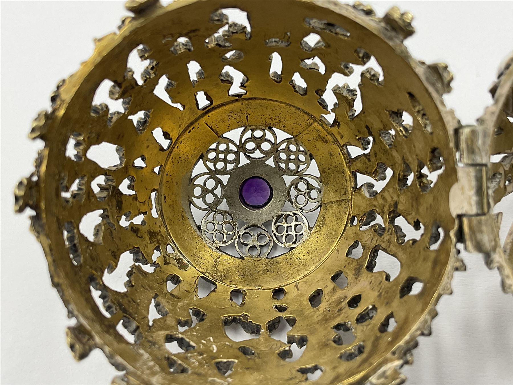Modern silver limited edition Easter egg, no. 70/500, the gilt openwork body decorated with cascading bluebells and hinged cover with pierced circular panel set with a single faceted purple stone, opening to reveal a gilt interior, upon silver stand with three scrolling pad feet, each hallmarked St James House Company, London 1981, height including stand 8cm