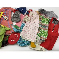 The World of Barbie Double Doll Case containing a quantity of assorted doll's clothing; together with two large and one small fashion dolls.