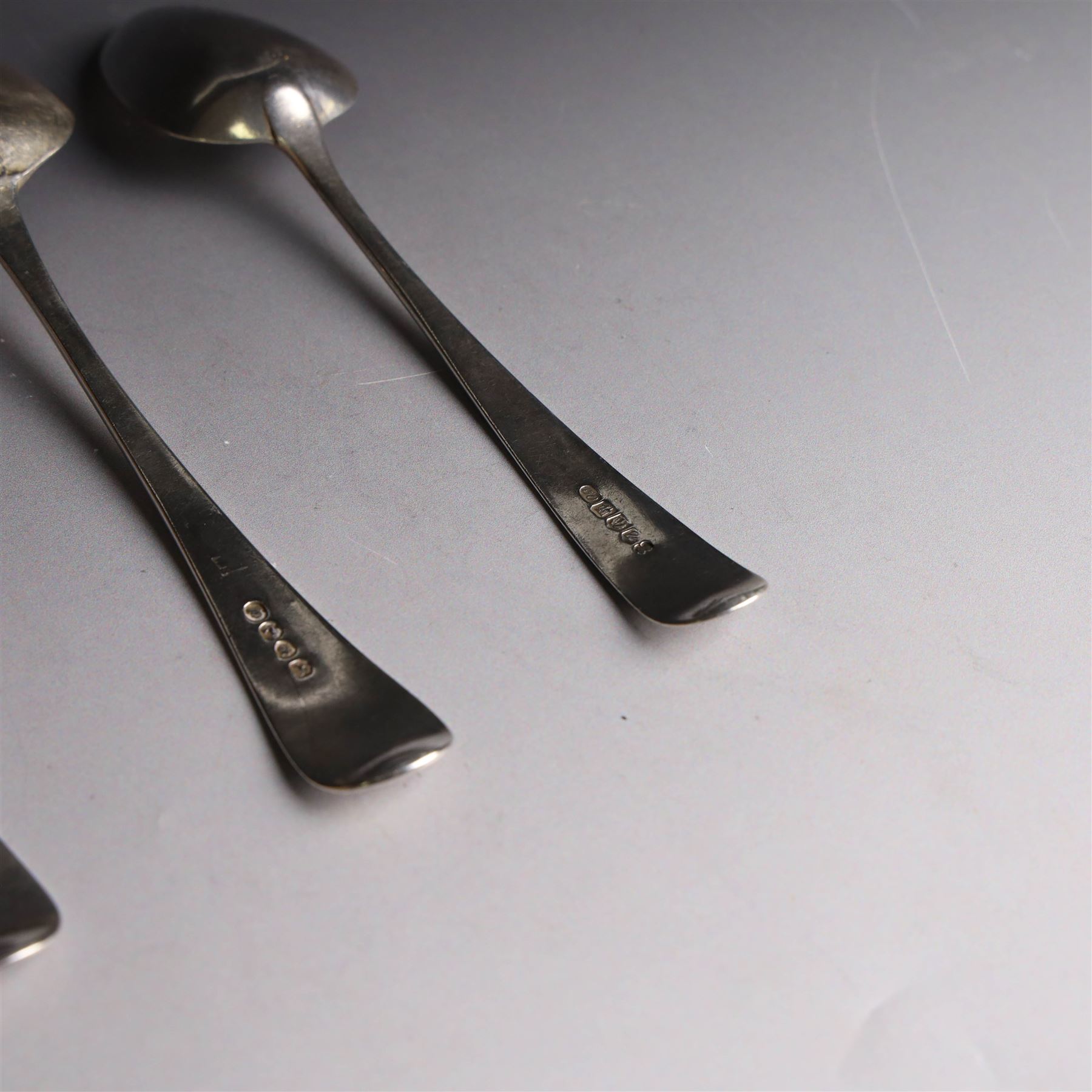 Three George III silver Old English pattern spoons, comprising table spoon with engraved monogram to terminal, hallmarked Thomas Wilkes Barker, London 1806, another table spoon hallmarked London 1806, and a Scottish silver dessert spoon hallmarked James Orr, Edinburgh 1805