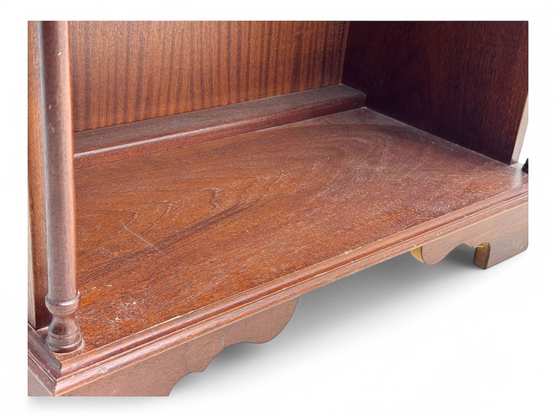 Mid-20th century mahogany open bookshelf, the rectangular top with a brass balustrade gallery, over three shelves each supported by turned column uprights, on shaped apron base