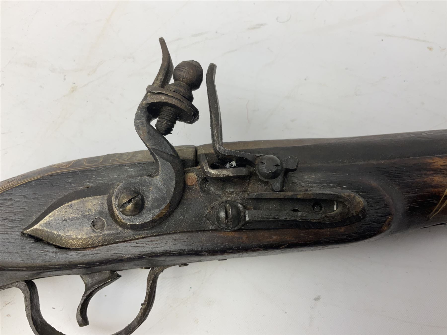 REGISTERED FIREARMS DEALERS ONLY - Reproduction flintlock pistol, the full walnut stock with brass filigree inlay and mounts and skull crusher butt L46cm; no visible proof marks - Disposed 25.06.25 - Notified 24.07.25