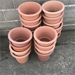 Twenty tapering terracotta pots, H31cm