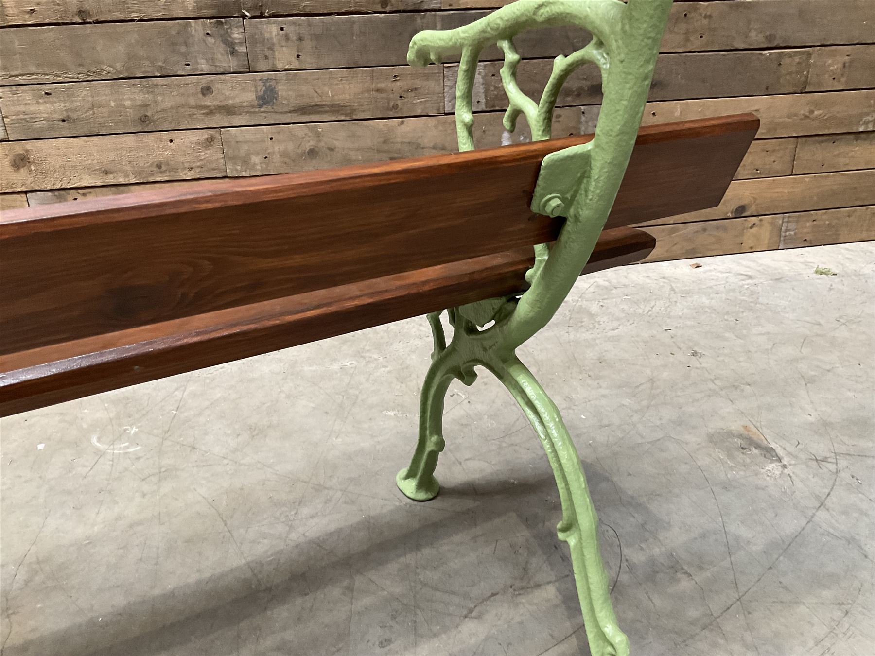 Cast iron and wood slate bench painted in green