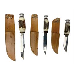 Graduated set of three Bowie knives by J. Nowill & Sons Sheffield England Est. AD1700, each with steel blade, brass cross-piece, antler grip and alloy pommel; largest blade 15.5cm and smallest 10cm; in matching leather sheaths (3)