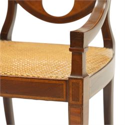 Hampton & Sons (Pall Mall 1830-1957) - Pair of Edwardian inlaid mahogany wheel-back elbow chairs, the pierced oval backs with chequered stringing and cross banding, out-swept arms over canework seats, banded seat rail over square tapering supports with spade feet, stamped to underside
Provenance: Kirkham Hall