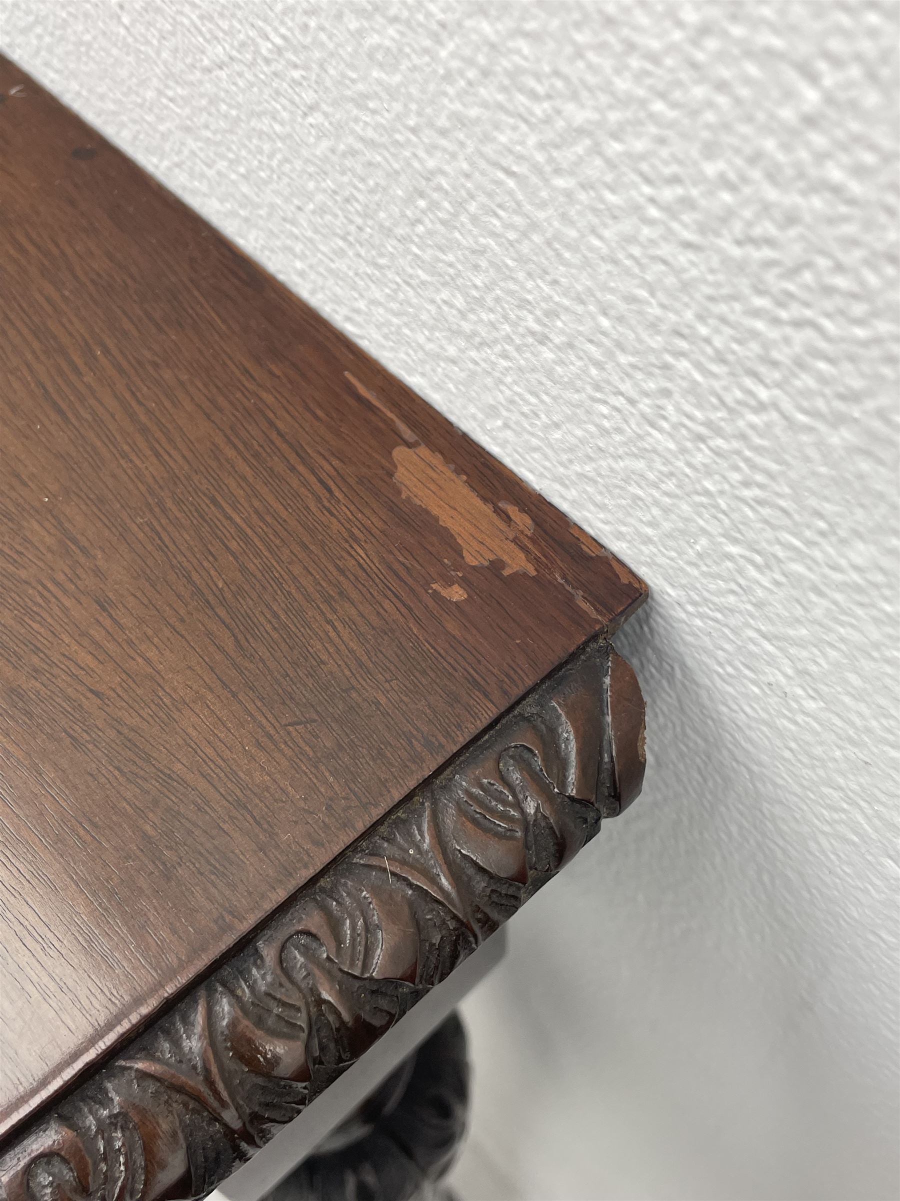 Pair early 20th century Hepplewhite style mahogany D-end console tables, the curved top with foliate carved edge, fluted frieze rails carved with flower heads, turned and reeded acanthus supports with recessed castors