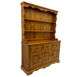 Pine farmhouse dresser with three drawers and three cupboards, and two tier plate rack