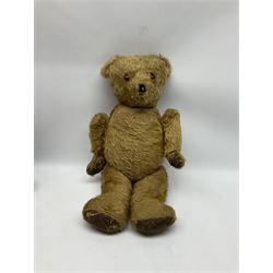 Mid-20th century plush covered teddy bear the revolving head with applied eyes, vertically stitched nose and jointed limbs with rexine pads H58cm; together with a leather backpack (2)