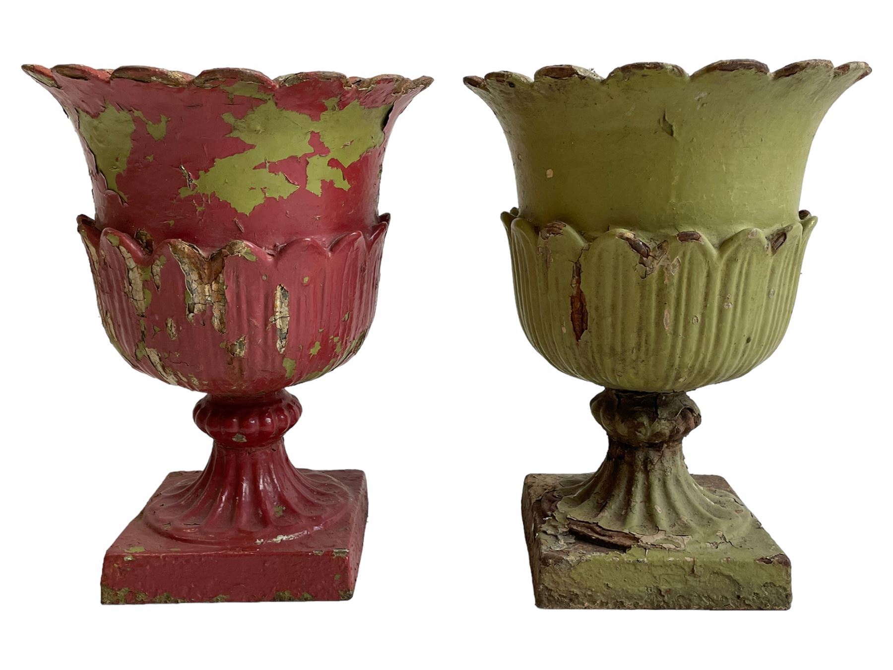 Pair of Victorian cast iron lotus garden urns, the shaped rim over lappet cast underbelly, on moulded footed base