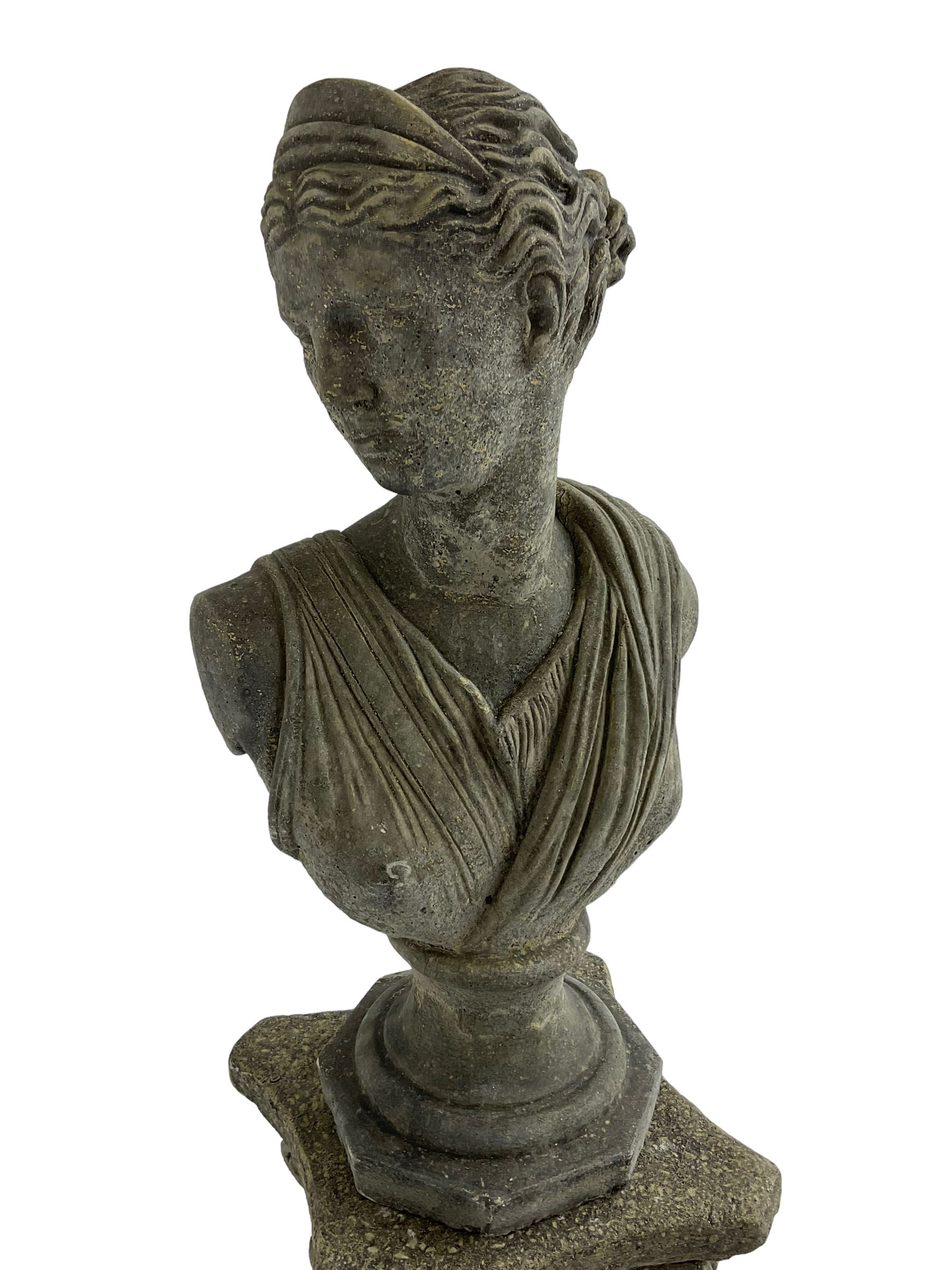 Classical design cast stone female bust depicting Artemis, raised on fluted Corinthian column with acanthus leaf capital, stepped square base, looking right 