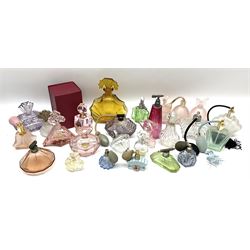 Art Deco style glass perfume bottles and atomisers, to include a large amber example with stopper of fan shape, H18cm, green glass examples with metal stoppers, and a number of other Art Deco style coloured bottles of geometric form with stoppers and mounts