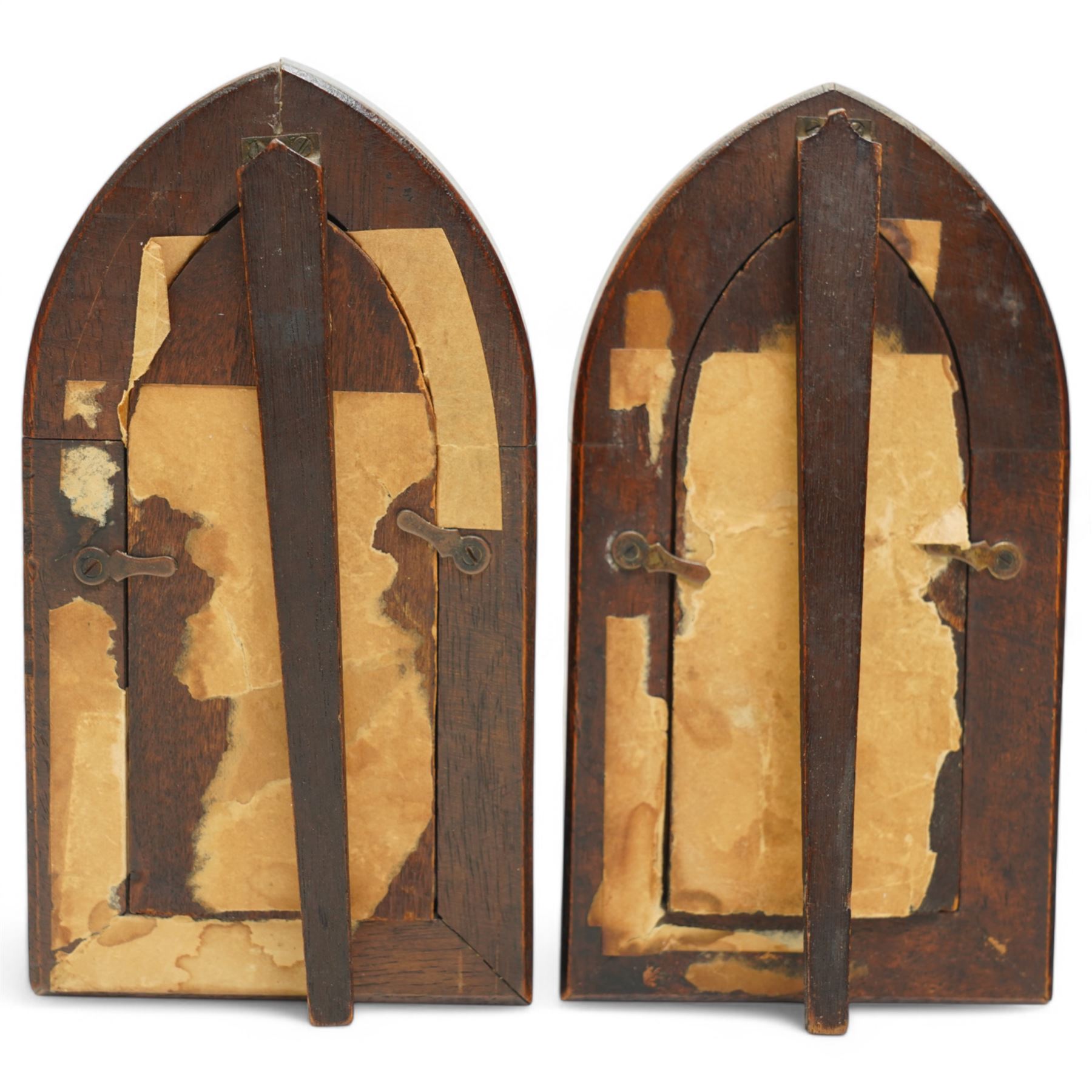 Pair of early 20th century continental painted porcelain religious icon plaques, depicting two angels playing a violin and a sackbut, heightened in gilt, within carved gothic frames, H15cm; together with a camphor wood box with carved decoration, W28cm (3)