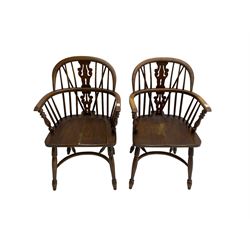 Pair late 20th century oak Windsor elbow chairs, double hoop and stick back with pierced and fretwork work splat, dished seat on turned supports joined by crinoline stretcher