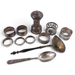 Silver pepper grinder, sifting ladle, silver handled spoon and eight silver napkin rings, ...