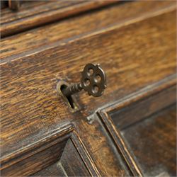 Early 20th century Jacobean Revival oak bureau-bookcase, astragal glazed doors enclosing two adjustable shelves, over geometric panelled fall-front enclosing fitted interior, over two drawers, raised on a spiral-turned base with barley-twist stretchers and compressed bun feet