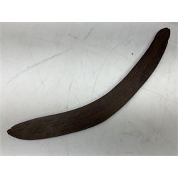 Australian aboriginal woomera spear thrower incised/carved with a wavy line and dots L69cm; and two boomerangs, one with carved geometric decoration (3)