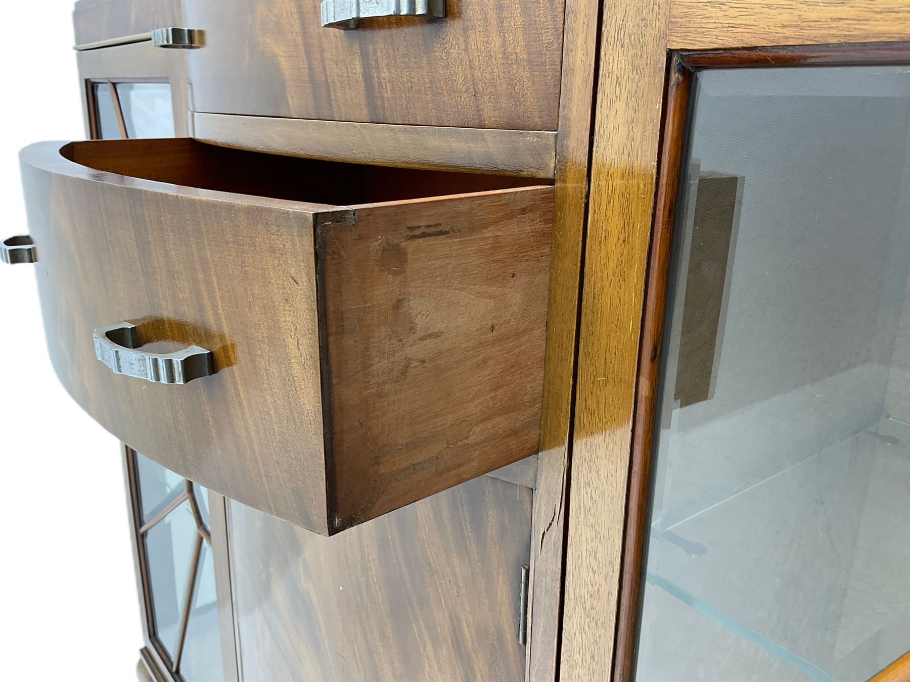 Mid-20th century Art Deco style walnut display cabinet, two central drawers over cupboard flanked by two bevel glazed display cabinets with sunburst astragal glazing, on ball and claw cabriole feet