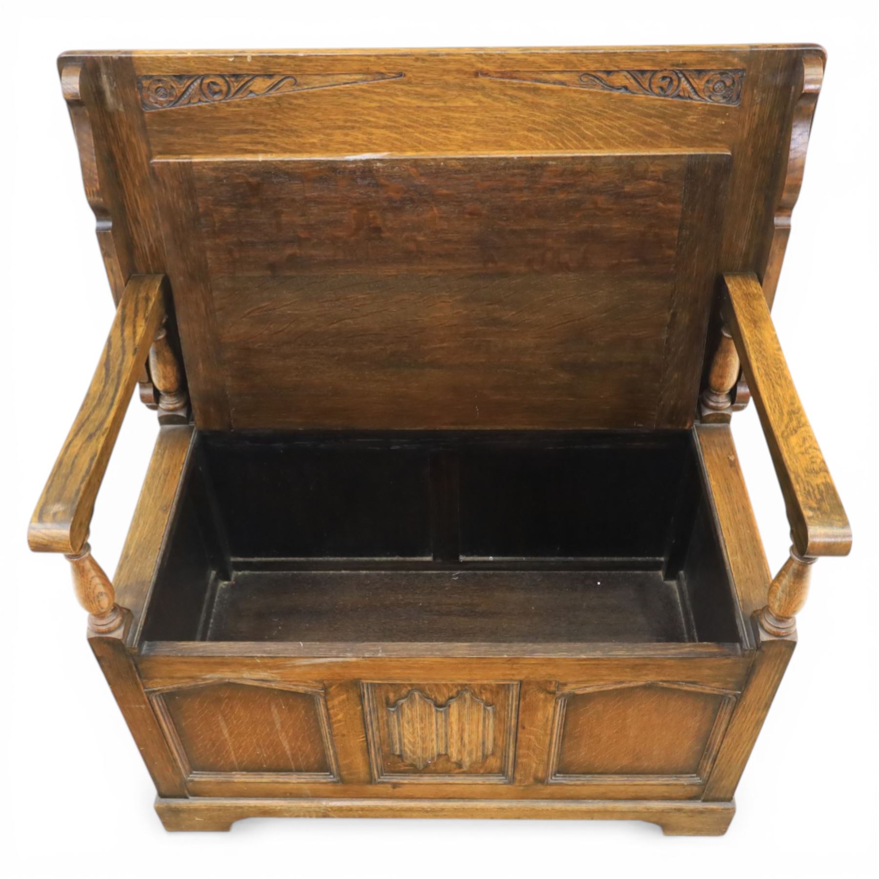 20th century oak monks bench with hinged box seat, with blind fretwork to the seat, panelled front and sides with linen fold panel in the centre