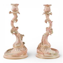 Royal Worcester pair of blush ivory candlesticks, modelled in the rococo style of scrollin...
