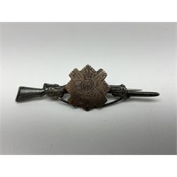 Popski's Private Army sterling silver cap badge; and two silver sweetheart brooches for Highland Light Infantry as a rifle and silver gilt Glengarry badge and Army Service Corps with blue enamel; and another silver badge (4)