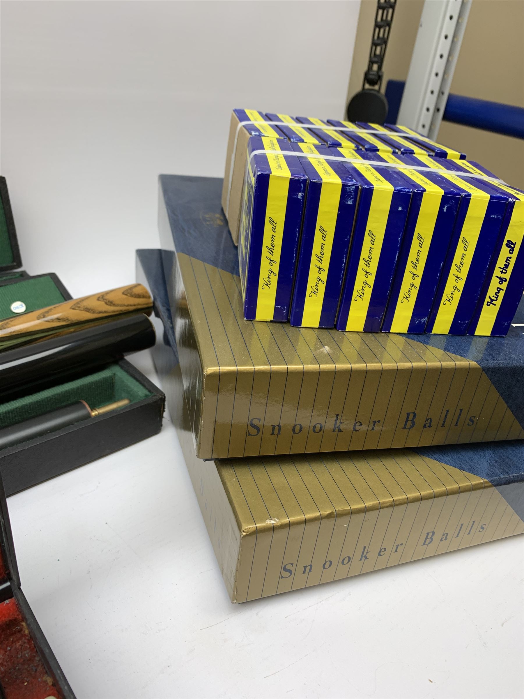 Collection of various snooker cues to include a Lewis & Wilson cue, Master Cue Makers, two other cues, three hard cases, two boxes of Snooker Balls, twelve boxes of chalk and related posters