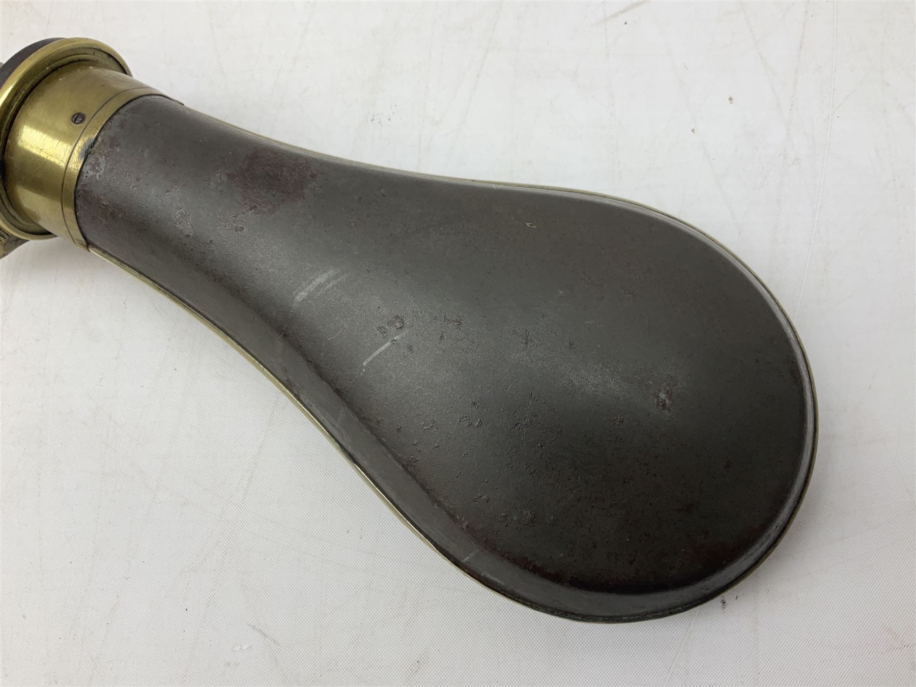 Two Sykes Patent brass mounted small load powder flasks with fire proof safety tops - one with slim plain copper body H17.5cm; the other with plain gun metal body H19cm (2)