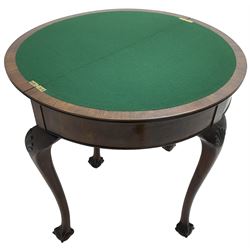 Early 20th century figured walnut demi-lune card table, fold-over reed moulded top with baize lined interior, pull-out rear support with storage well, on shell carved cabriole supports with ball and claw feet