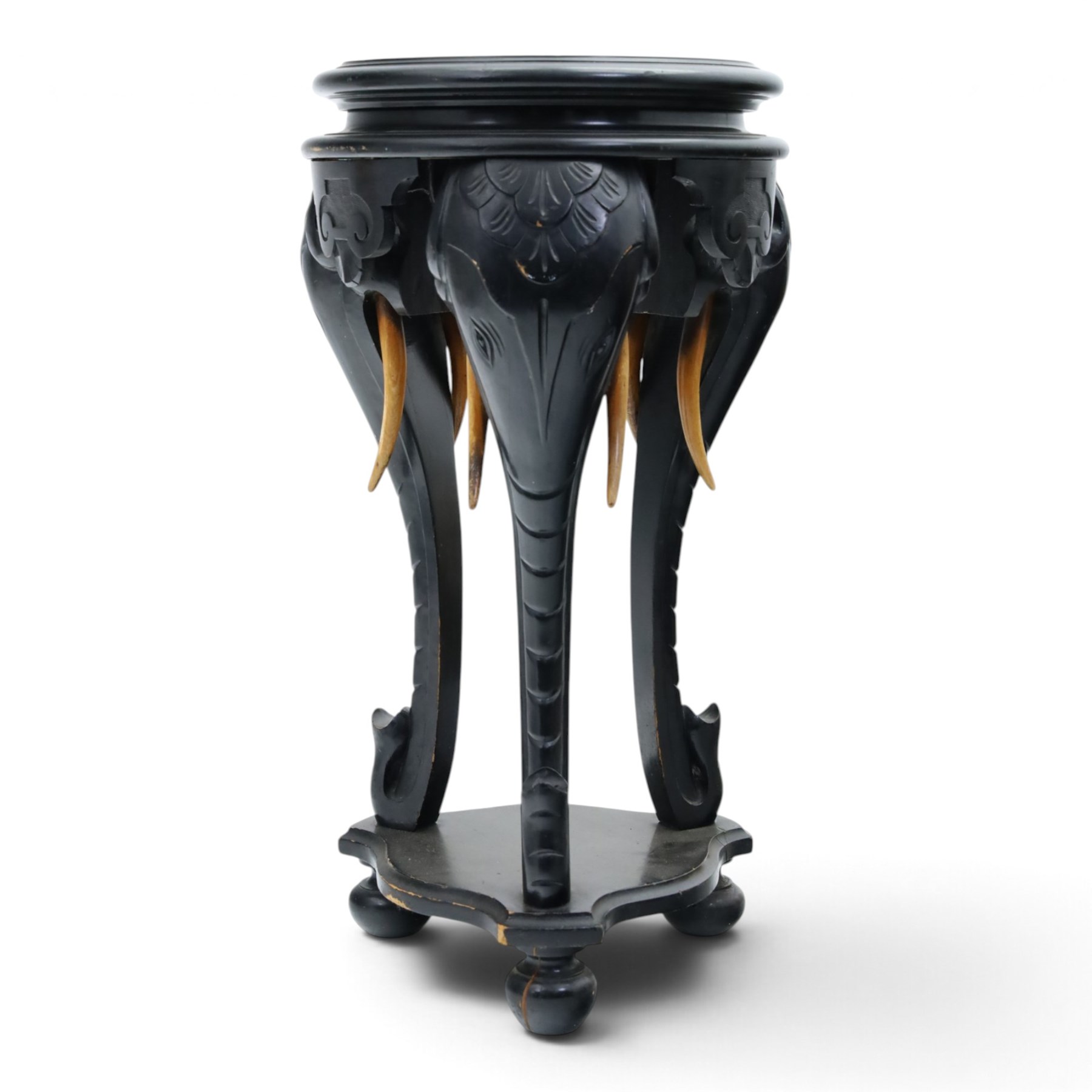 Elephant ebonised jardinière, moulded circular top raised on carved Elephant supports united by a shaped undertier