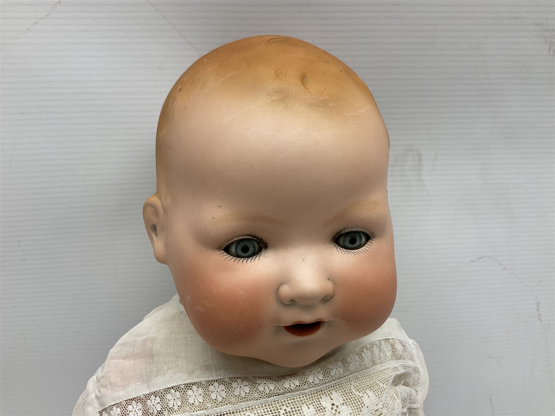 Heubach Koppelsdorf Germany bisque head doll with applied hair, sleeping eyes, open mouth with teeth and composition body with jointed limbs; marked 'Heubach Koppelsdorf 342.6/0 Germany' H34cm; Armand Marseille bisque head baby doll with moulded hair, sleeping eyes, open mouth and composition body with jointed limbs; marked 'A.M. Germany 351./8.K.; and BND London all composition doll (3)