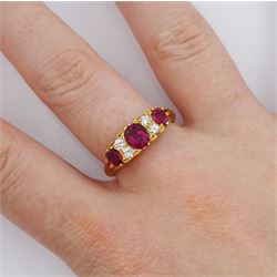 18ct gold three stone oval cut ruby and four stone round brilliant cut diamond ring, Birmingham 1972