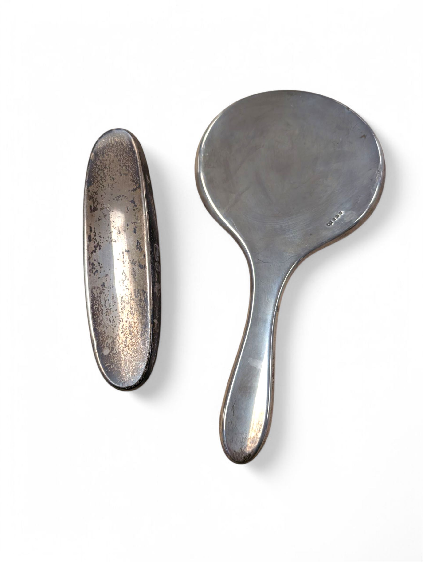 Silver mounted hand mirror and clothes brush, both hallmarked 