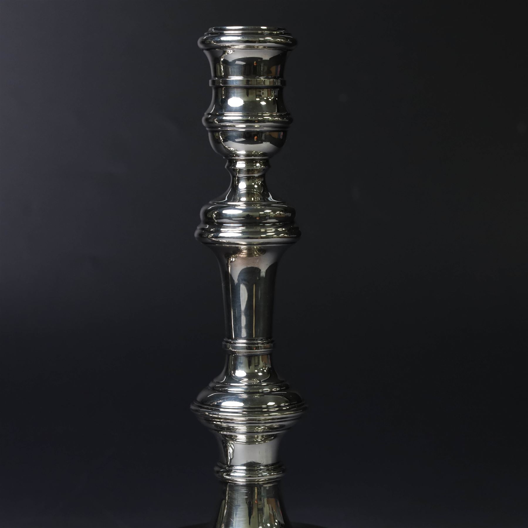 Pair of silver candlesticks, with knopped stems and upon spreading circular weighted bases, hallmarked William Comyns & Sons Ltd, London 1979, H20cm