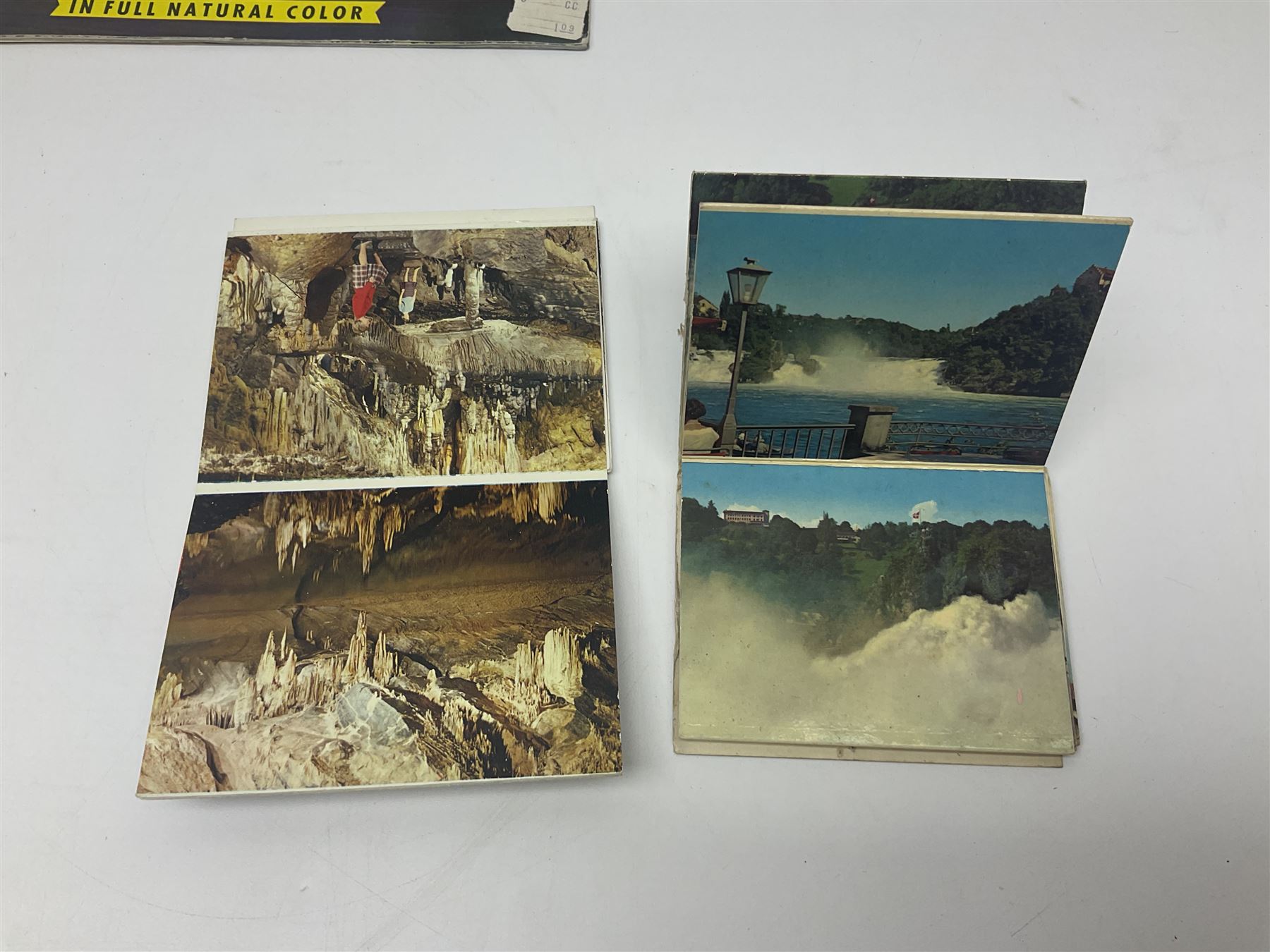 Seven pen knives, two lighters, including one Ronson example and a collection of postcards