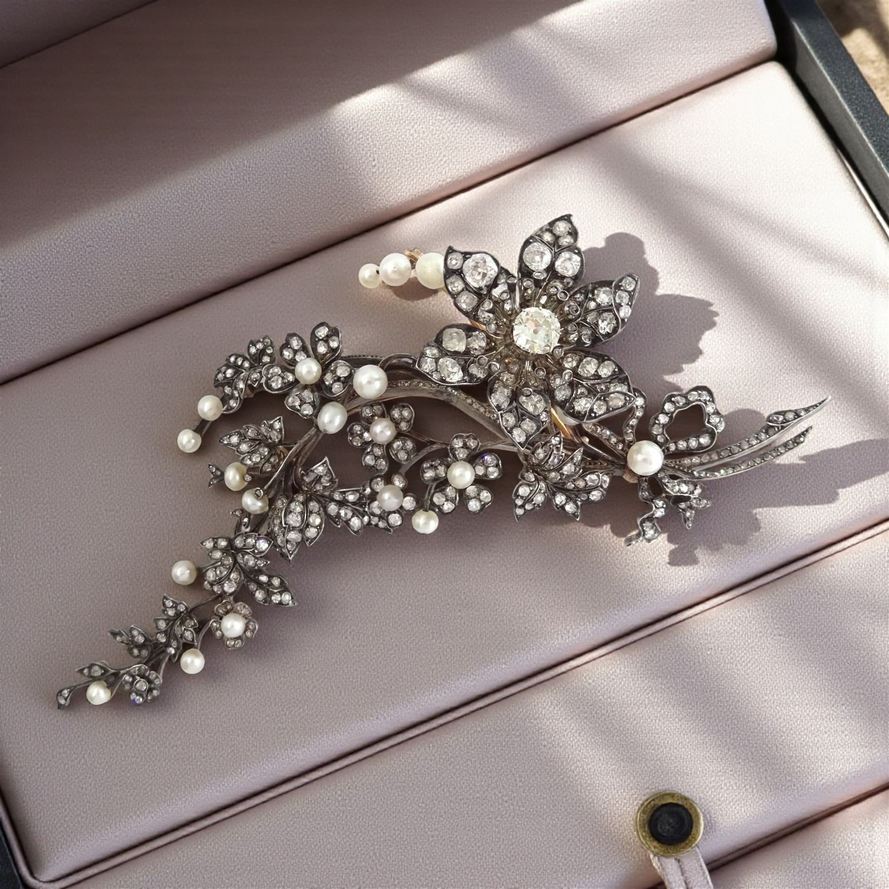 19th century gold and silver diamond and pearl en tremblant detachable brooch, the flower tremblant with a principal old cut diamond of approx 1.90 carat, the petals and stamen set with old cut and rose cut diamonds, total diamond weight approx 9.10 carat, to a foliate spray set set with further rose cut diamond and white / pink / cream pearls and ribbon tie