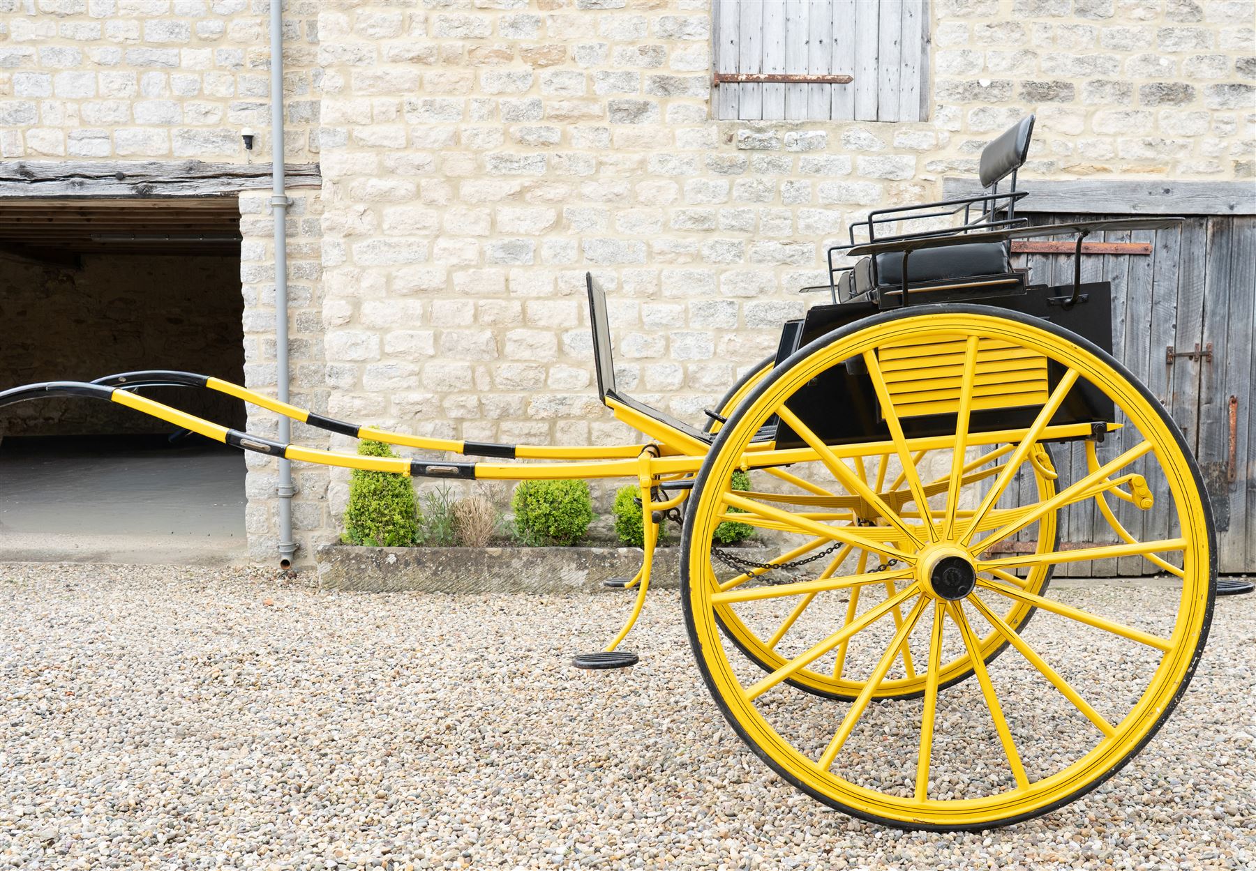 J. W. Thompson Dog Cart

A black and yellow painted two wheeled dog cart with elevated upholstered seat for two, buttoned black leather cushions, high back rail, folding front footboard, louvred sides, side steps, rear drop-down tailboard with chain stays, internal storage compartment, wooden spoked wheels, rubber tyres and shafts for a single horse. The wheel hubs are marked J W Thompson

Dimensions:
Overall length: 366 cm
Width: 160 cm
Height: 190 cm

Wheel Diameter:
Wheels: 139 cm

Seating:
Driver and passenger: 2