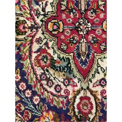 Persian red ground rug, overall floral design with central medallion, trailing foliate border with guards