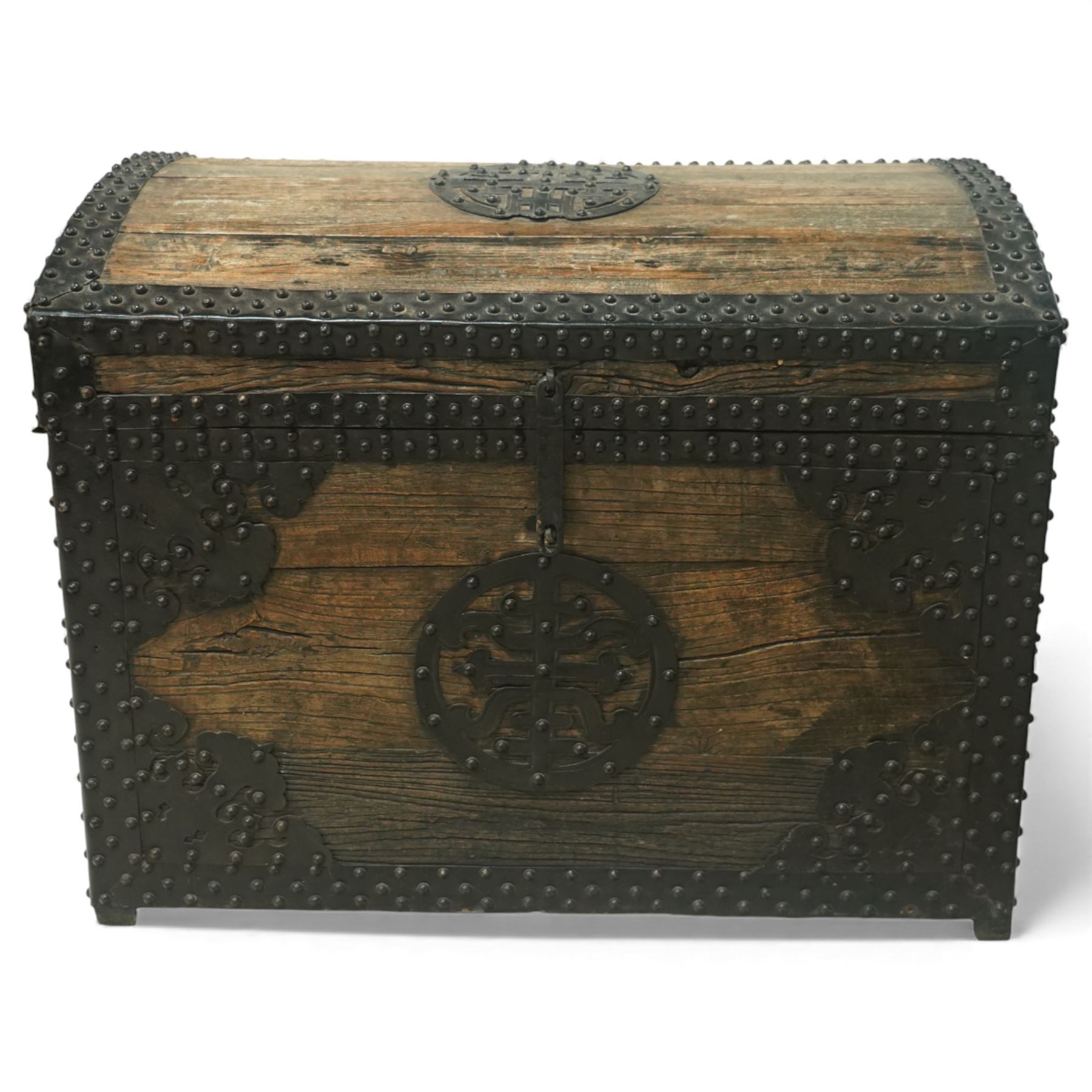 20th century Chinese camphorwood chest, the hinged lid opening to a plain interior, the exterior fitted with heavy iron strapwork, studded mounts and shaped corner plates, central circular lock escutcheon, with iron carrying handles