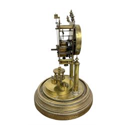 German - Gustav Becker BHA torsion clock c1900 on a circular stepped brass base with a glass dome, skeleton movement raised on two pillars with finials, small enamel dial with arabic numerals, spade hands and a adjustable rotary pendulum, torsion spring intact.