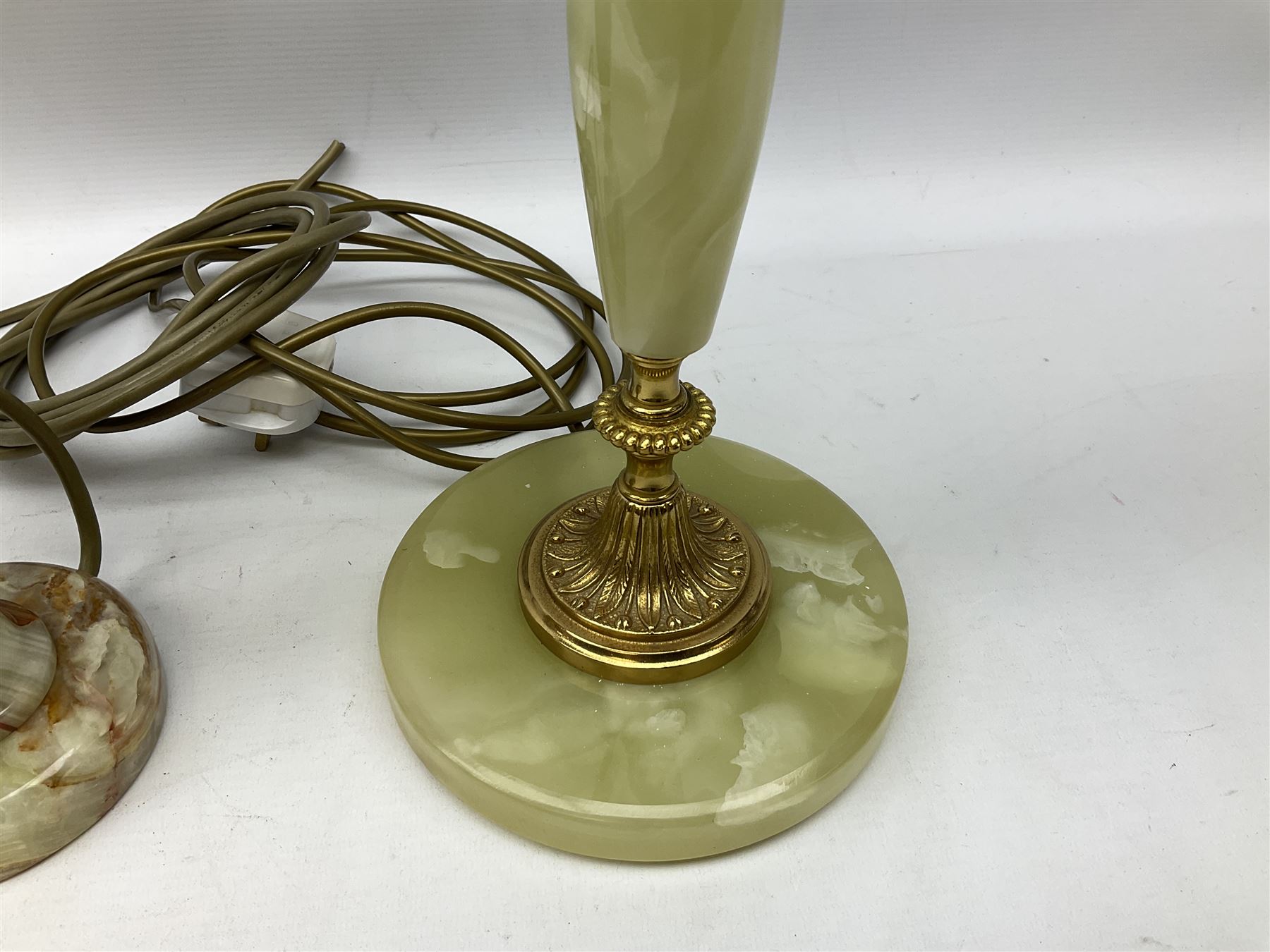  20th century gilt metal and onyx four branched candelabra upon a circular base, and onyx table lamp in the form of an urn, tallest example H48cm