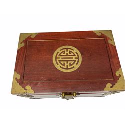 Chinese hardwood jewellery box mounted with engraved brass fixtures, the two exterior doors revealing three drawers below the hinged upper lid, lined with red material decorated with floral sprays, H25cm, W36cm, D23cm
