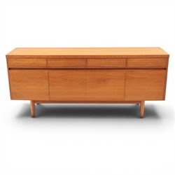 Mid-20th century teak sideboard, rectangular top above four frieze drawers with recessed h...