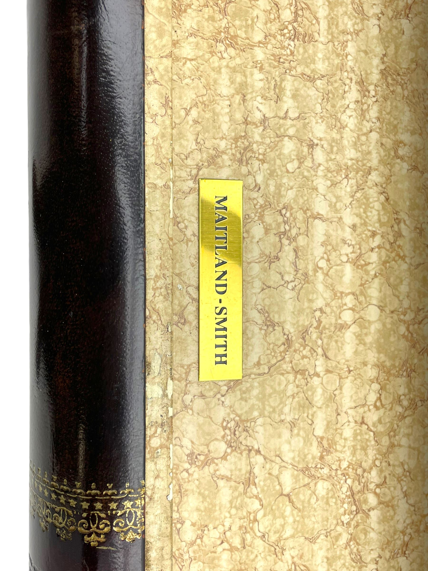 Maitland-Smith - four drawer chest in the form of a stack of leather-bound books, the top drawer with metal label inscribed 'Maitland-Smith', on turned feet